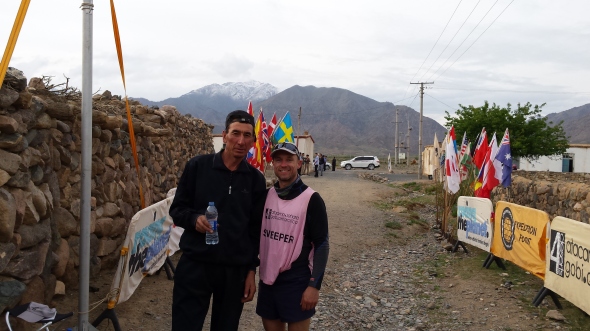 At the end of a hard day, Azaki the Kazakh-Chinese guide rests to take some water with me. He was a stud, hiking and climbing a marathon a day just like the competitors. He never complained.